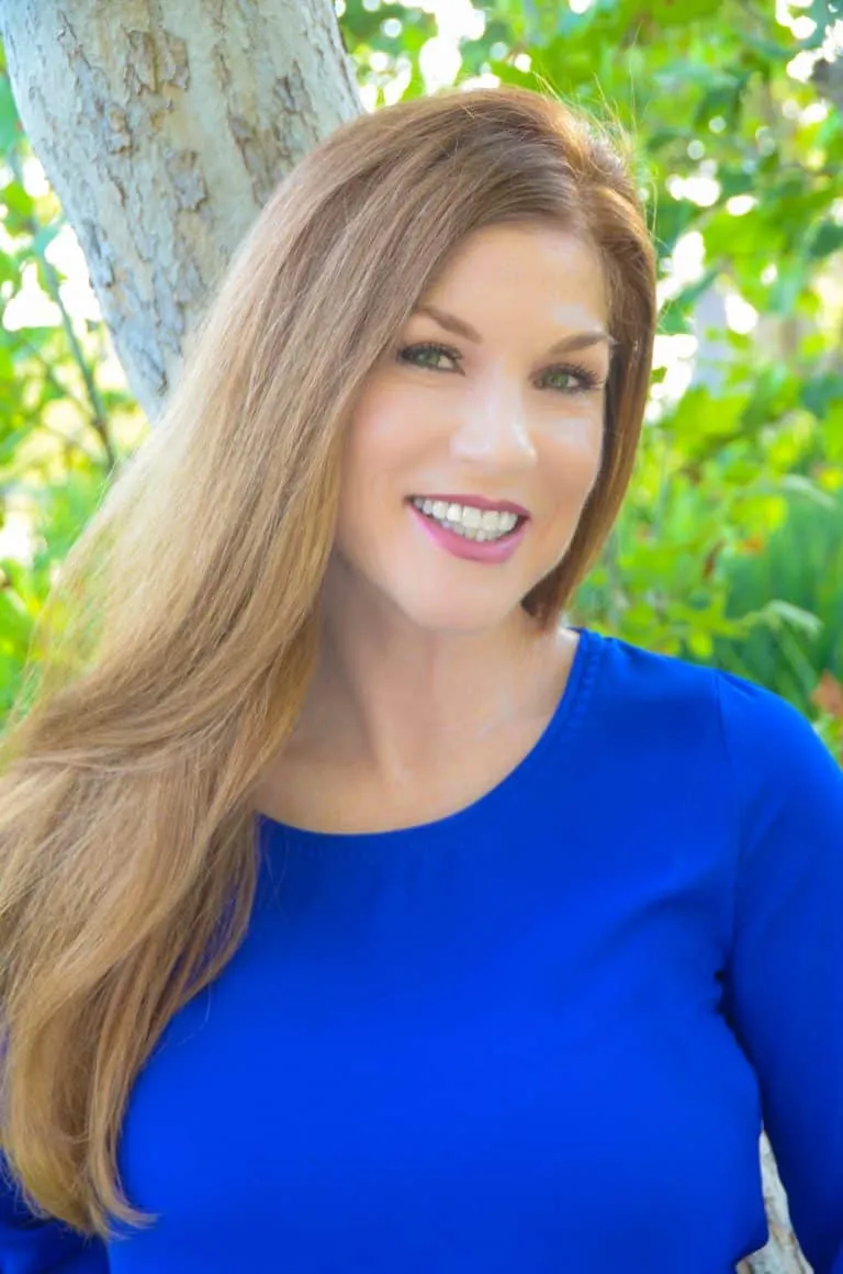 Dr. Tammy Bradshaw-Scott smiling outdoors in a blue top